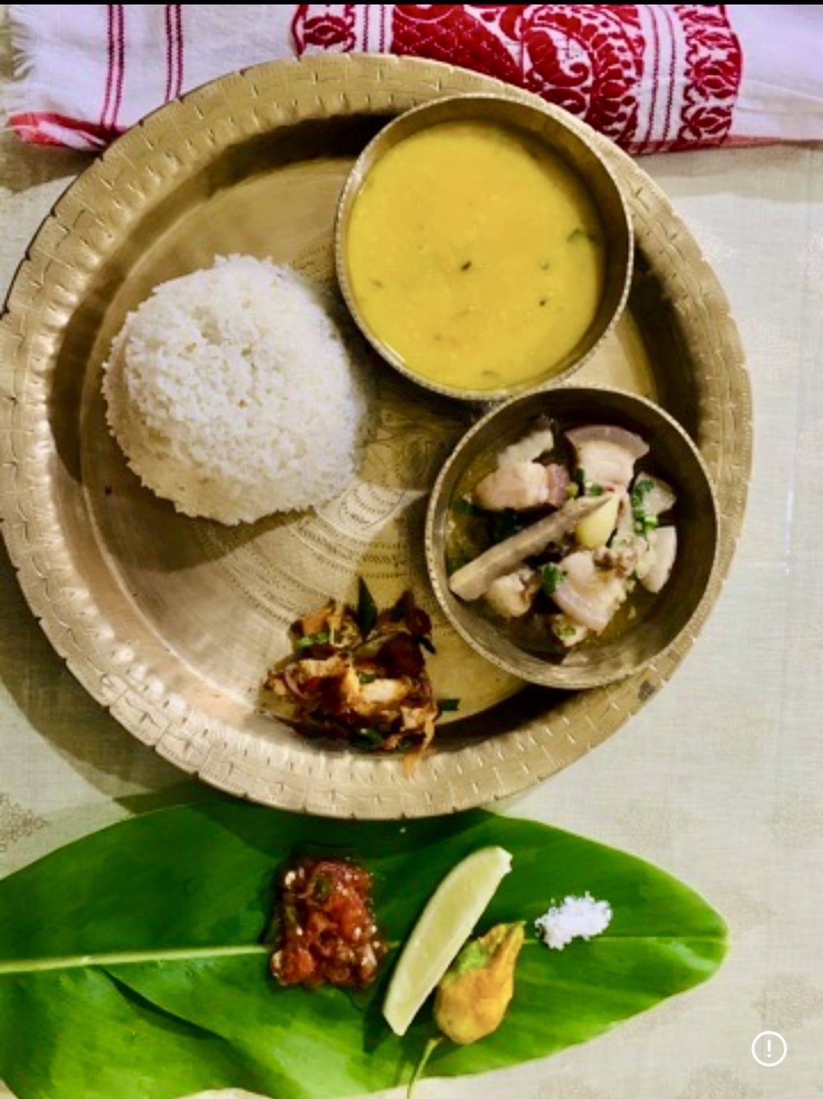 Warm family kitchen scene with traditional Assamese cooking